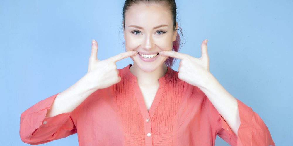smiling girl with coral color blouse